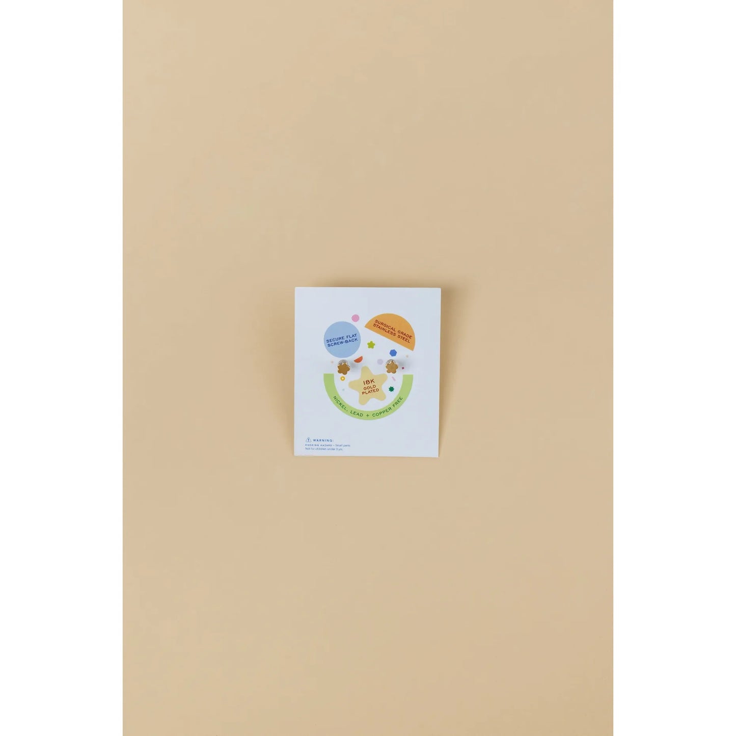 Small white card with colorful graphics on a beige background