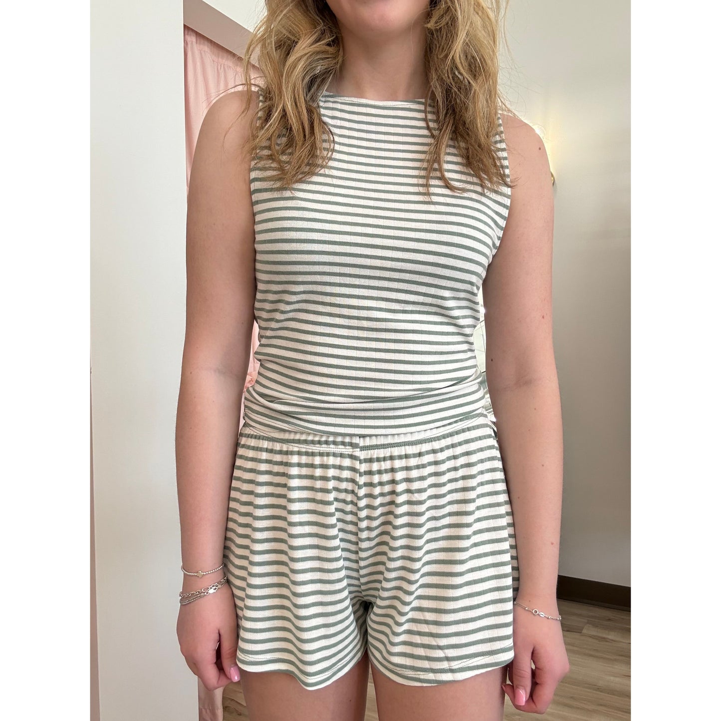 Women wearing a striped pajama shorts and tank top set. 