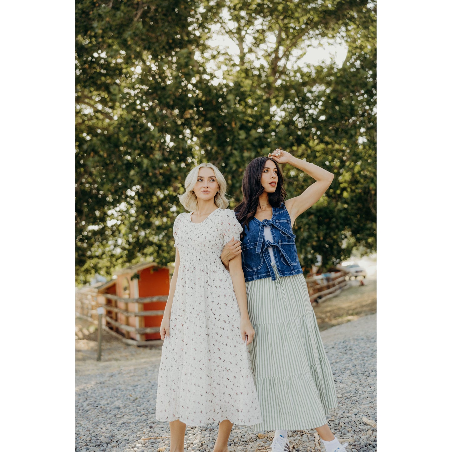 Woman wearing a striped green and white skirt along with another woman wearing a dress.