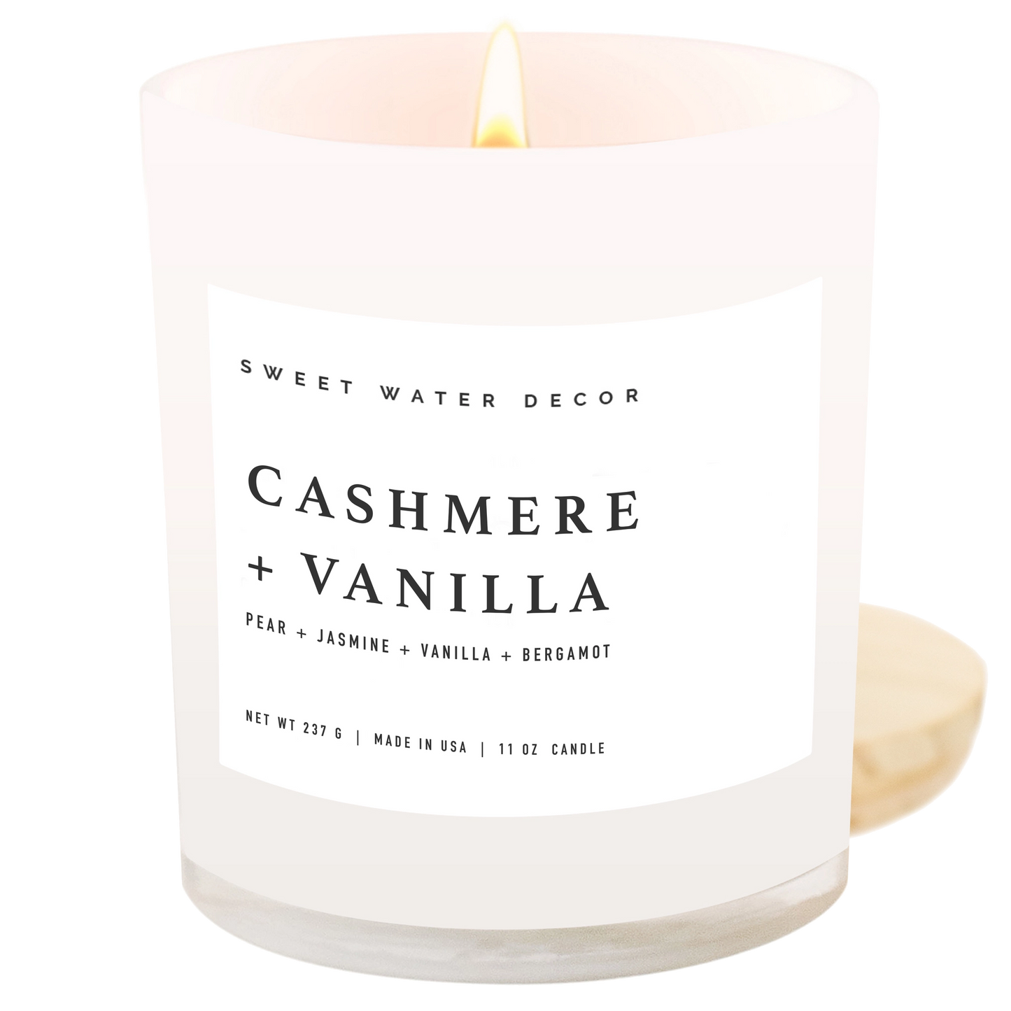 Candle labeled 'Cashmere + Vanilla' by Sweet Water Decor on a white background