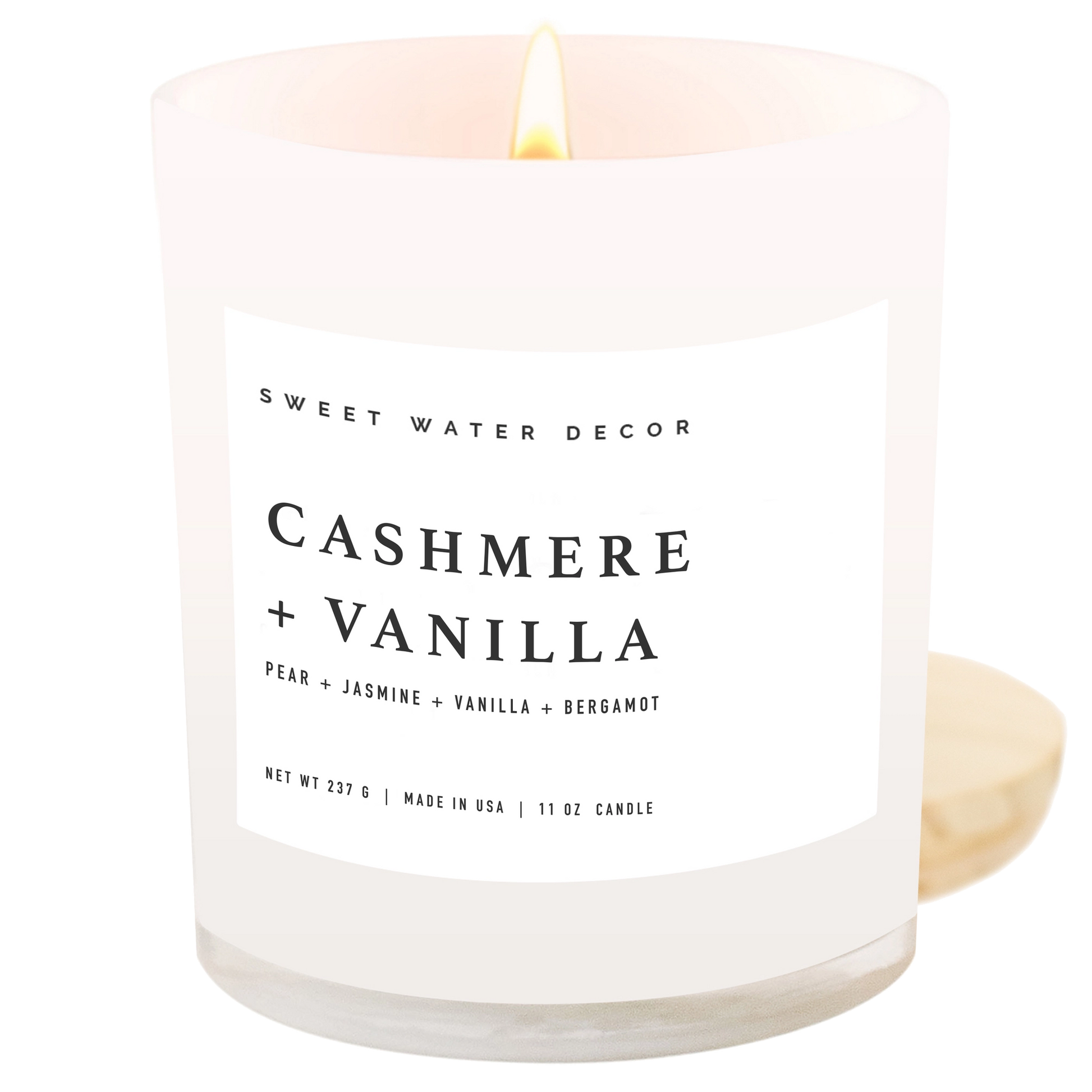 Candle labeled 'Cashmere + Vanilla' by Sweet Water Decor on a white background