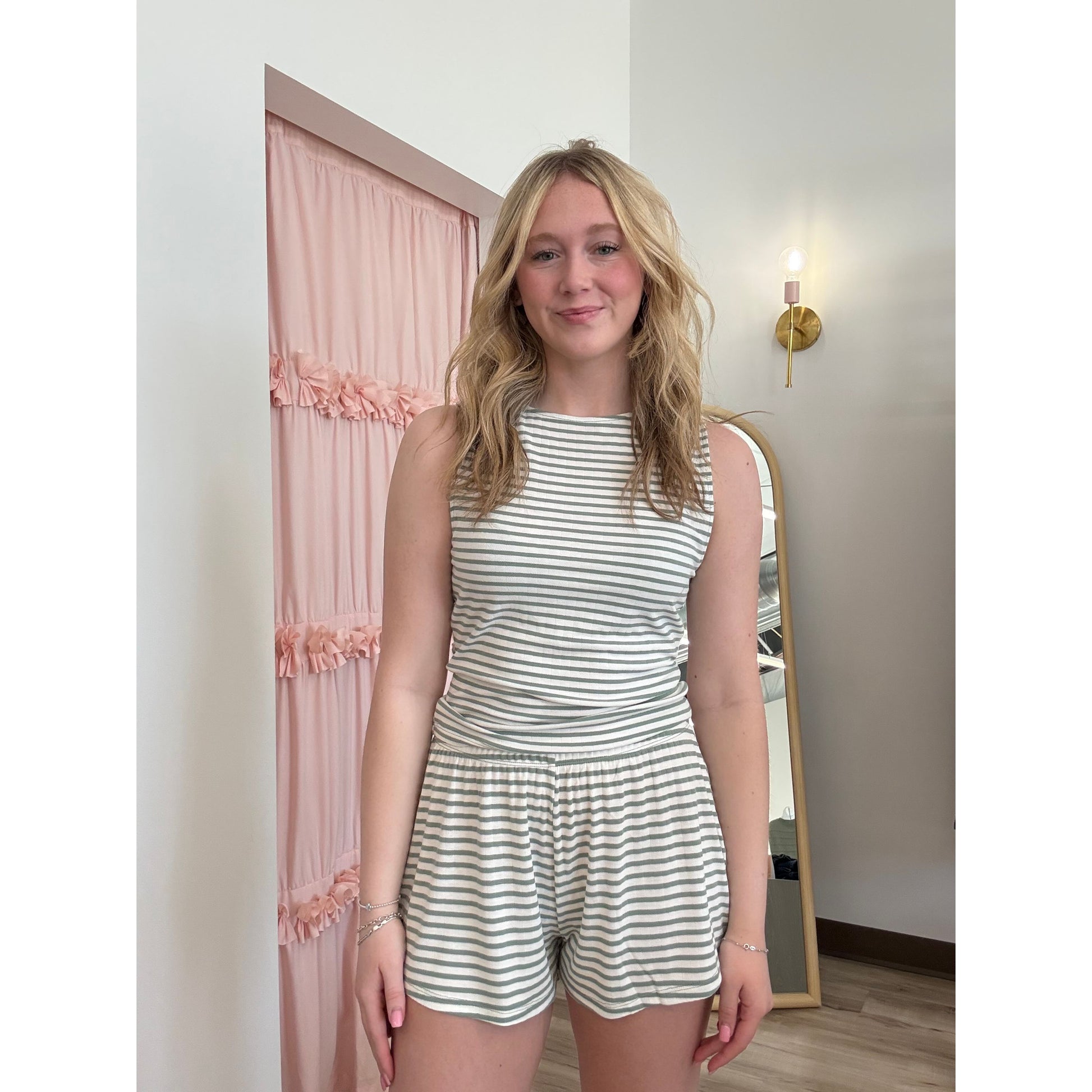 Women wearing a striped pajama shorts and tank top set. 