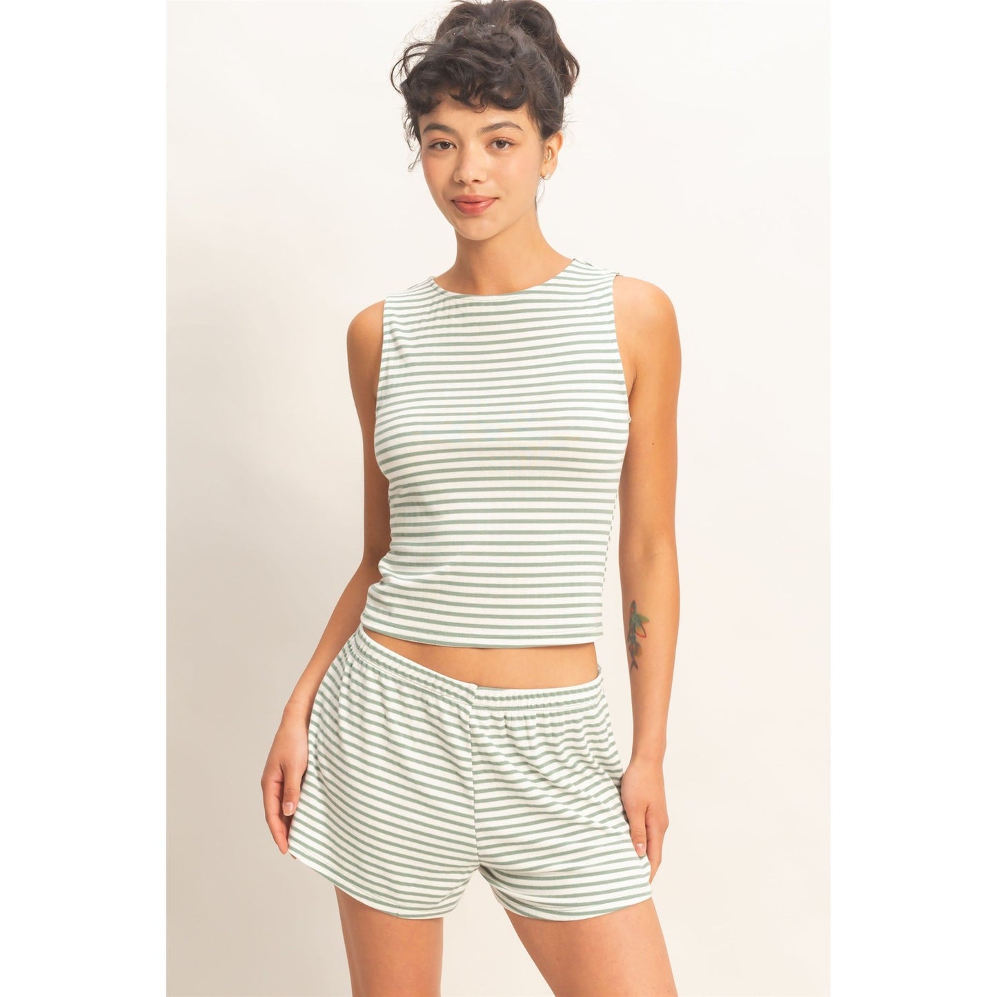 Women wearing a striped pajama shorts and tank top set. 