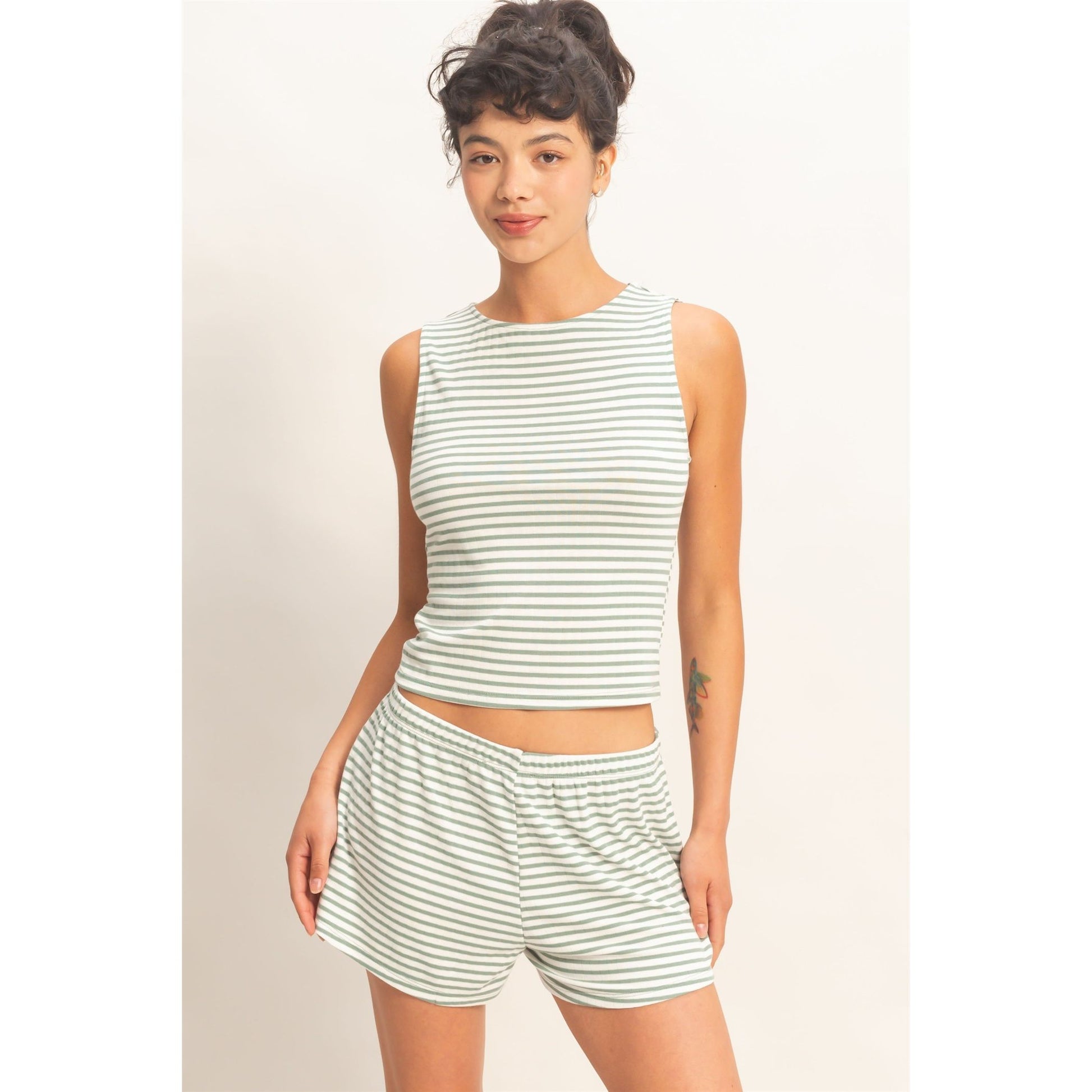 Women wearing a striped pajama shorts and tank top set. 