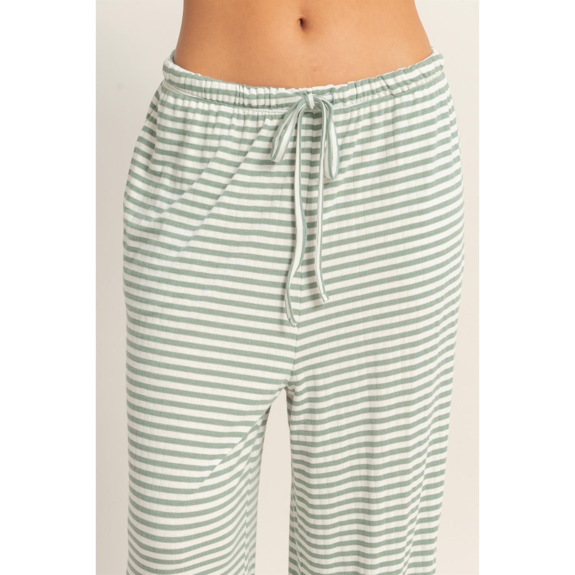 Women wearing a striped pajama pants and tank top set. 