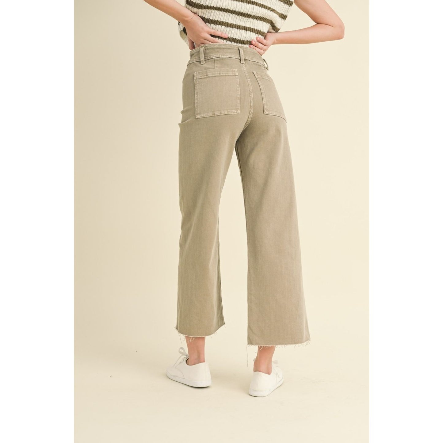 Back view of person wearing stone color wide-leg jeans with a frayed hem