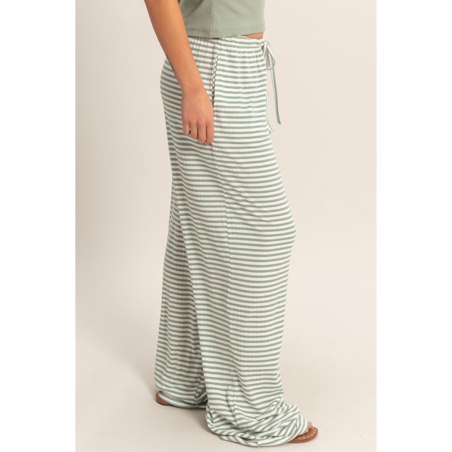 Women wearing a striped pajama pants and tank top set. 