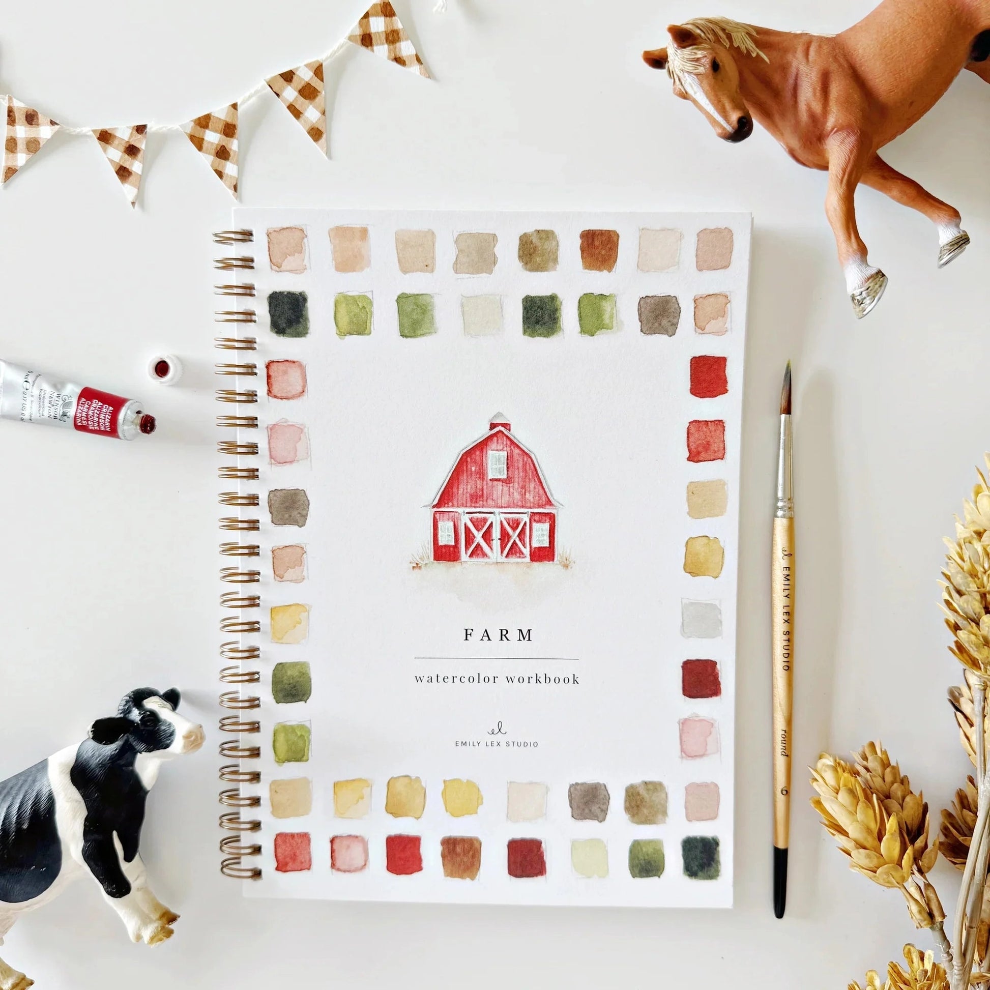 Color swatch workbook titled 'Farm' with a barn illustration, surrounded by farm-themed items on a white surface.
