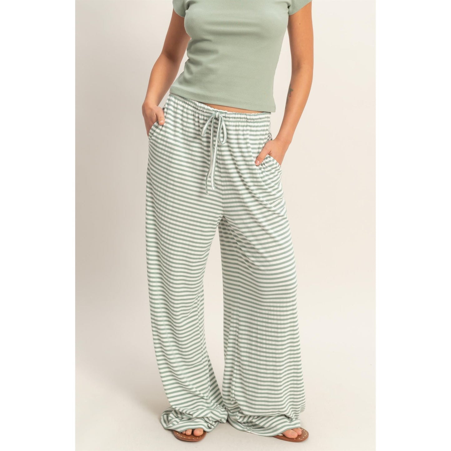 Women wearing a striped pajama pants and tank top set. 