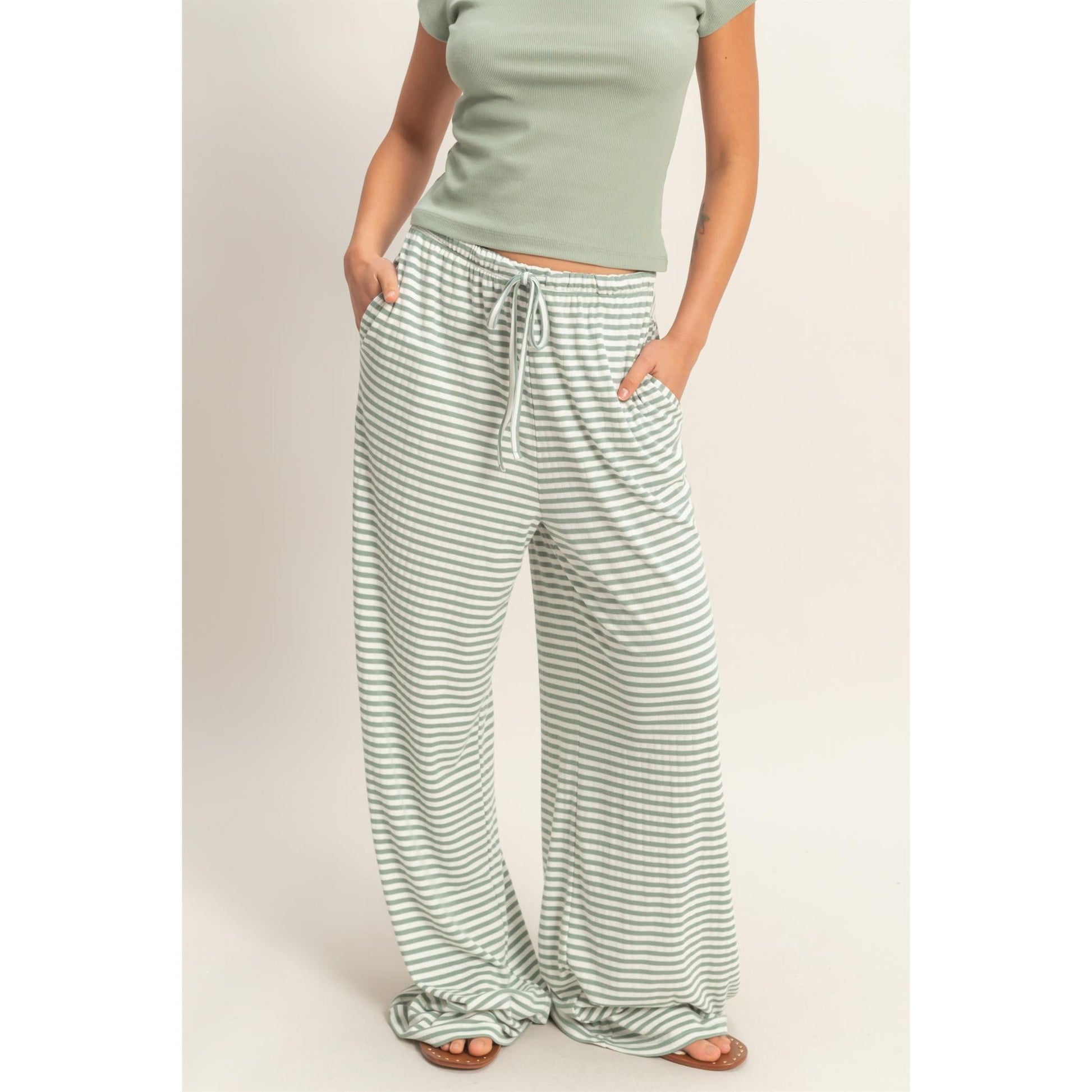 Women wearing a striped pajama pants and tank top set. 