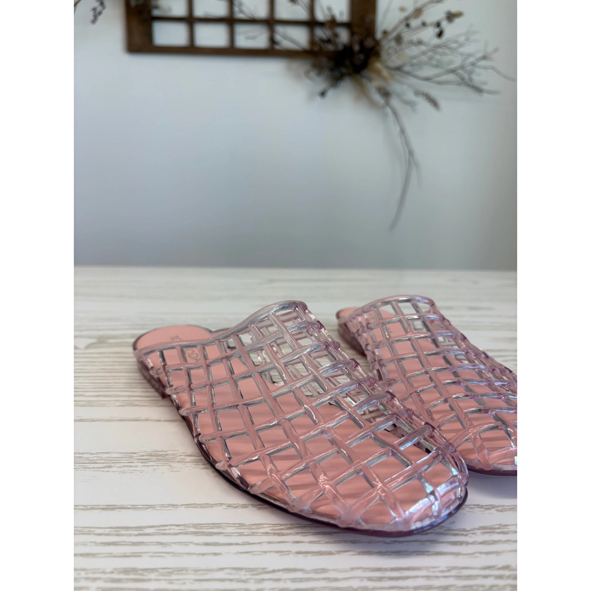 Pair of pink woven jelly slippers.