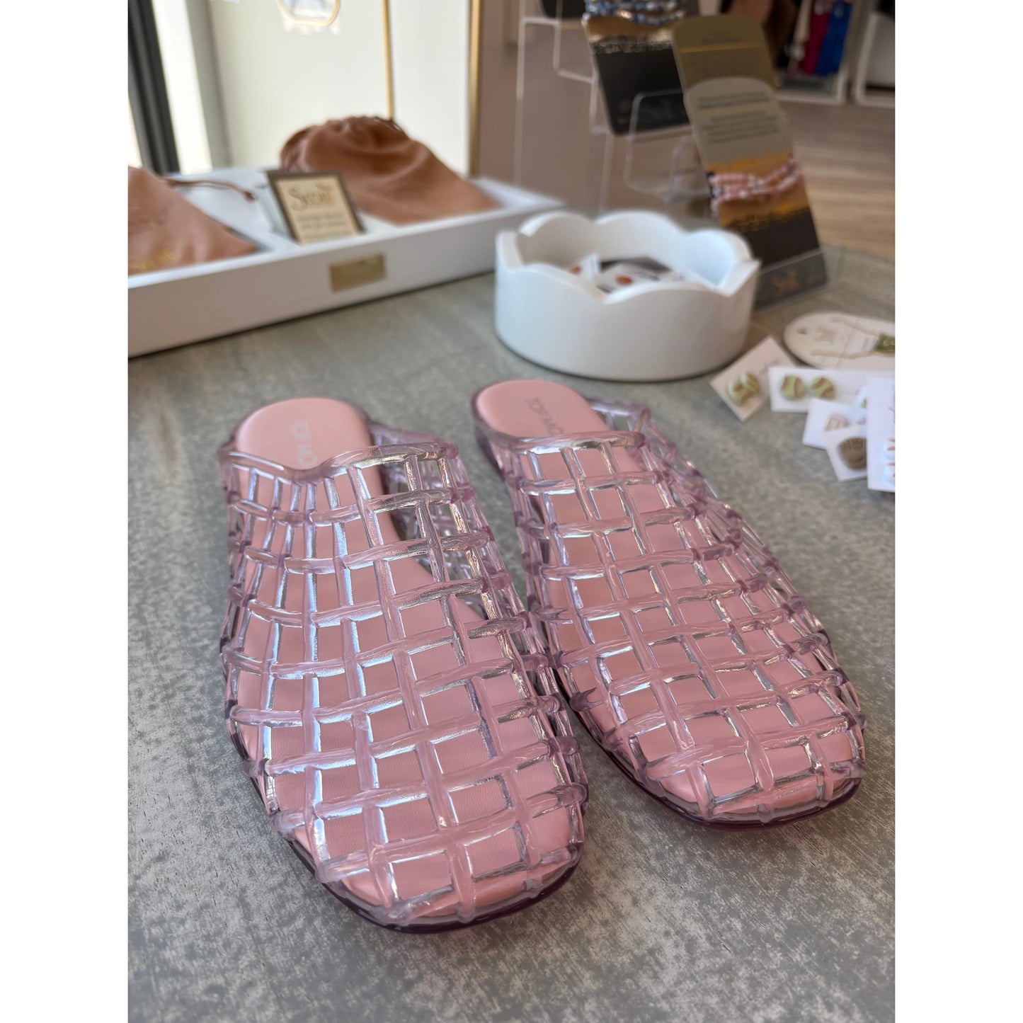 Pair of pink woven jelly slippers.