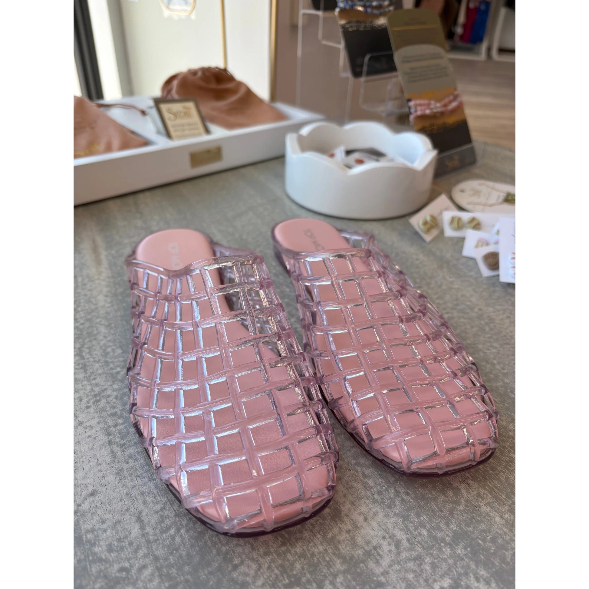 Pair of pink woven jelly slippers.