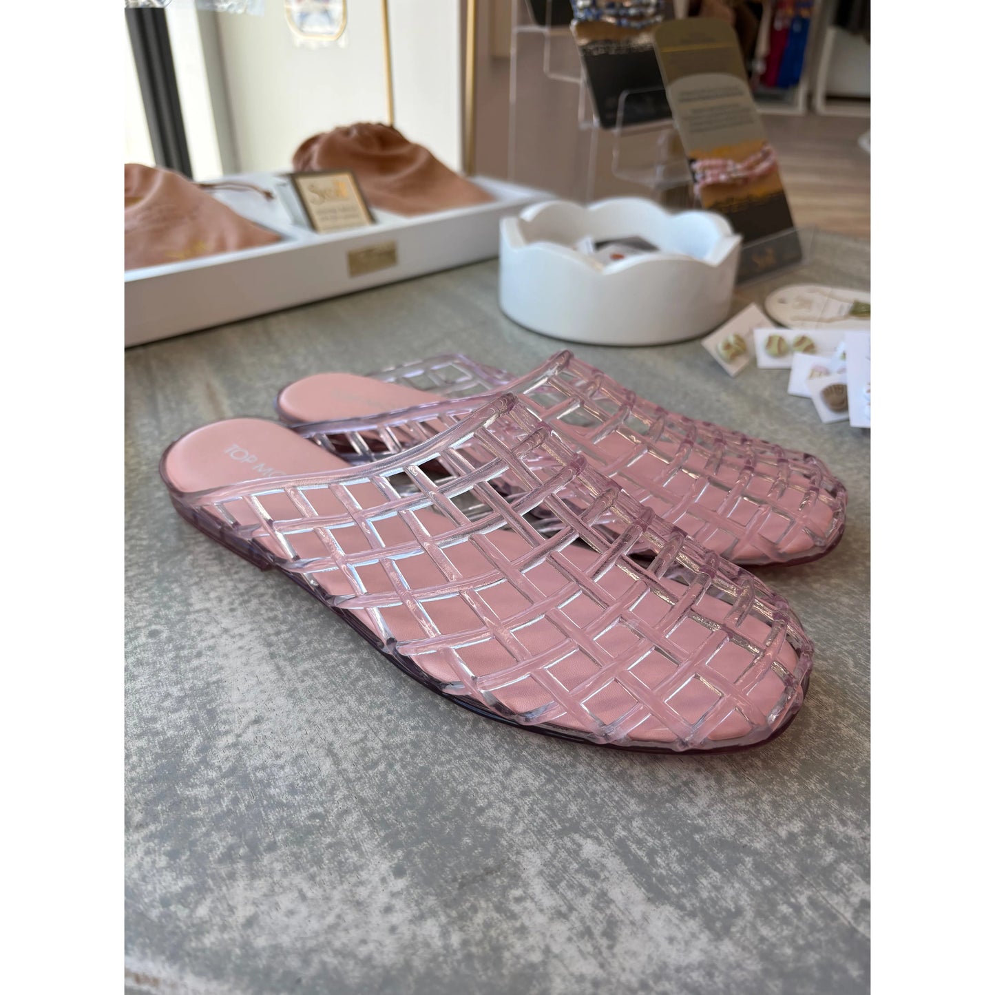Pair of pink woven jelly slippers.