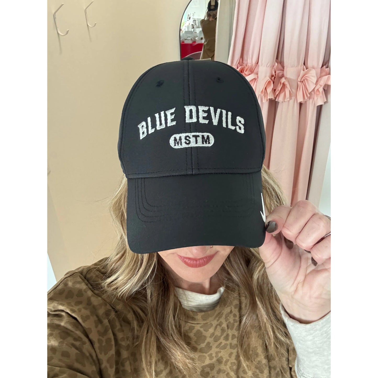 Person wearing a black Nike hat with 'Blue Devils MSTM' text 