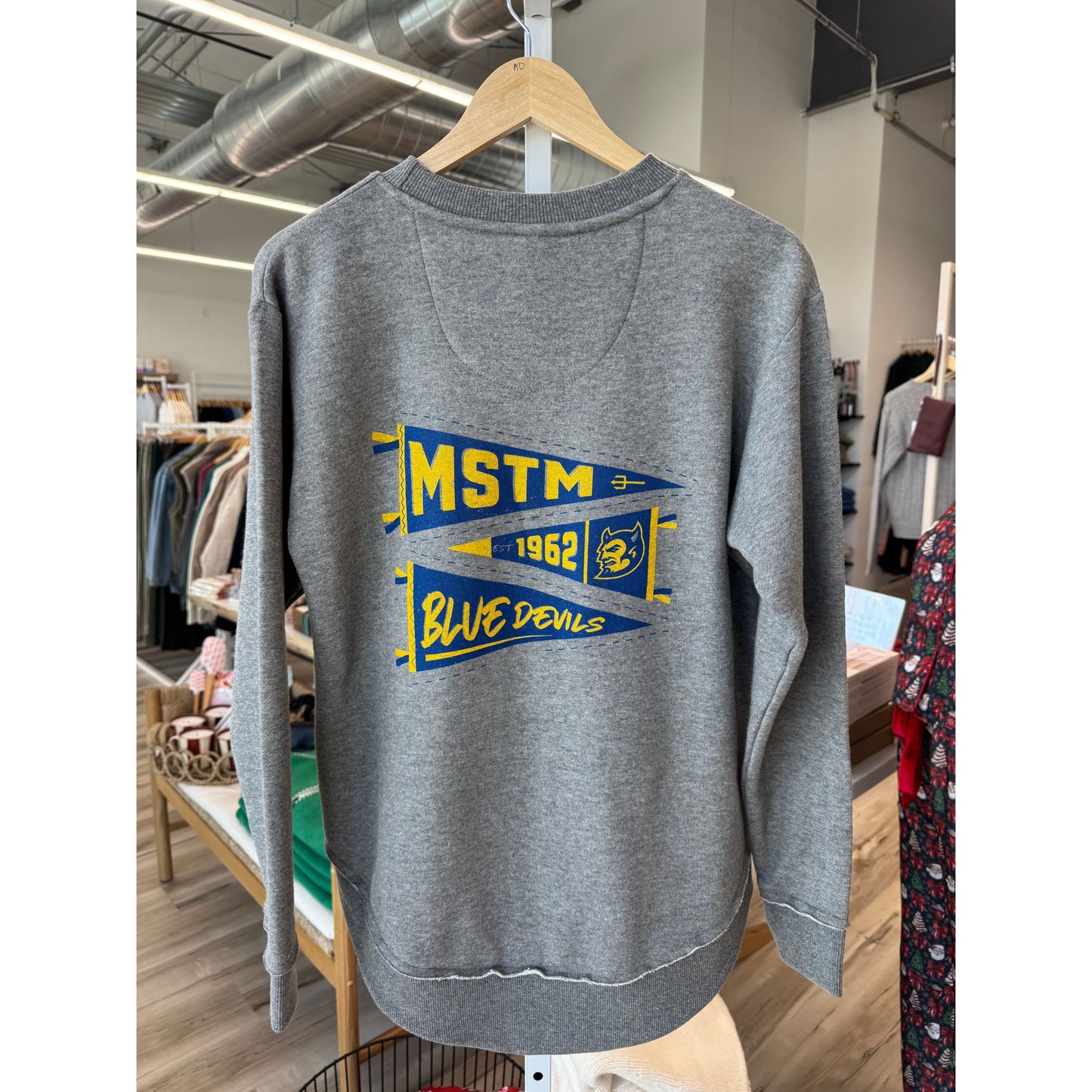 Gray t-shirt with 'MSTM' and 'Blue Devils' text on a hanger