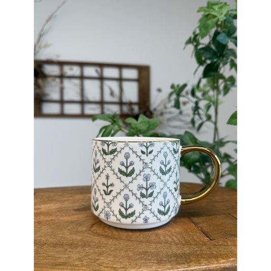 Floral quilted mug with gold handle.