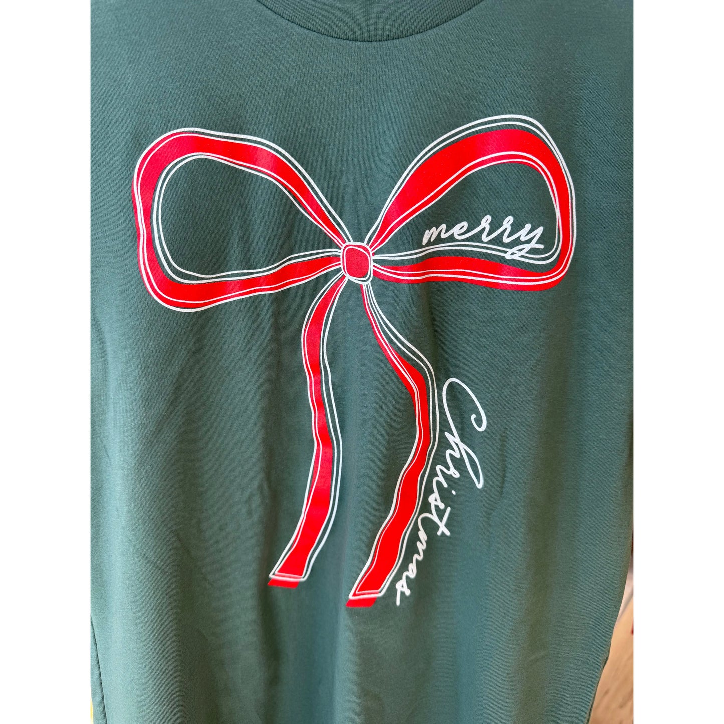 Green shirt with a red bow graphic and 'merry Christmas' text 