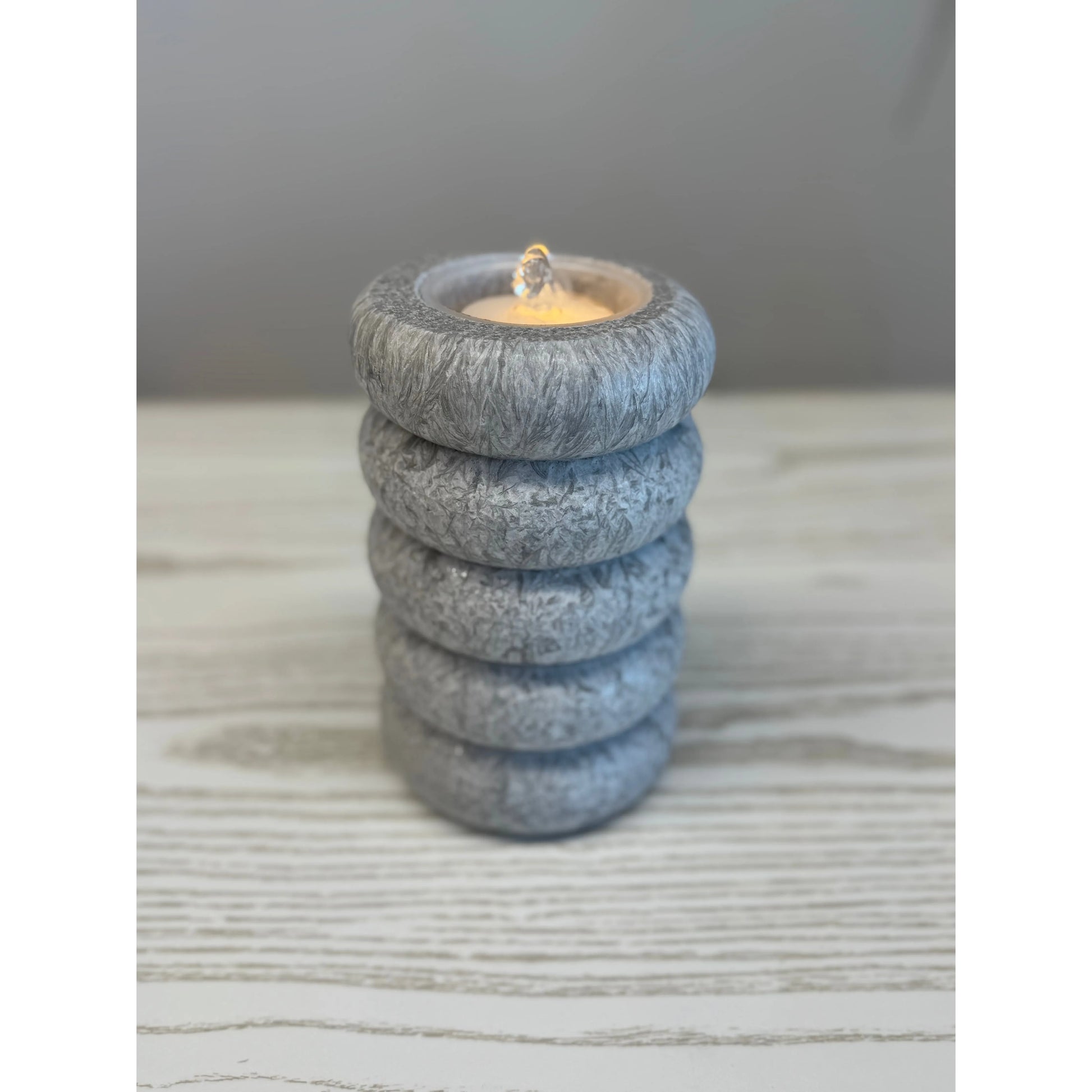 Stack of gray stone rings with water fountain