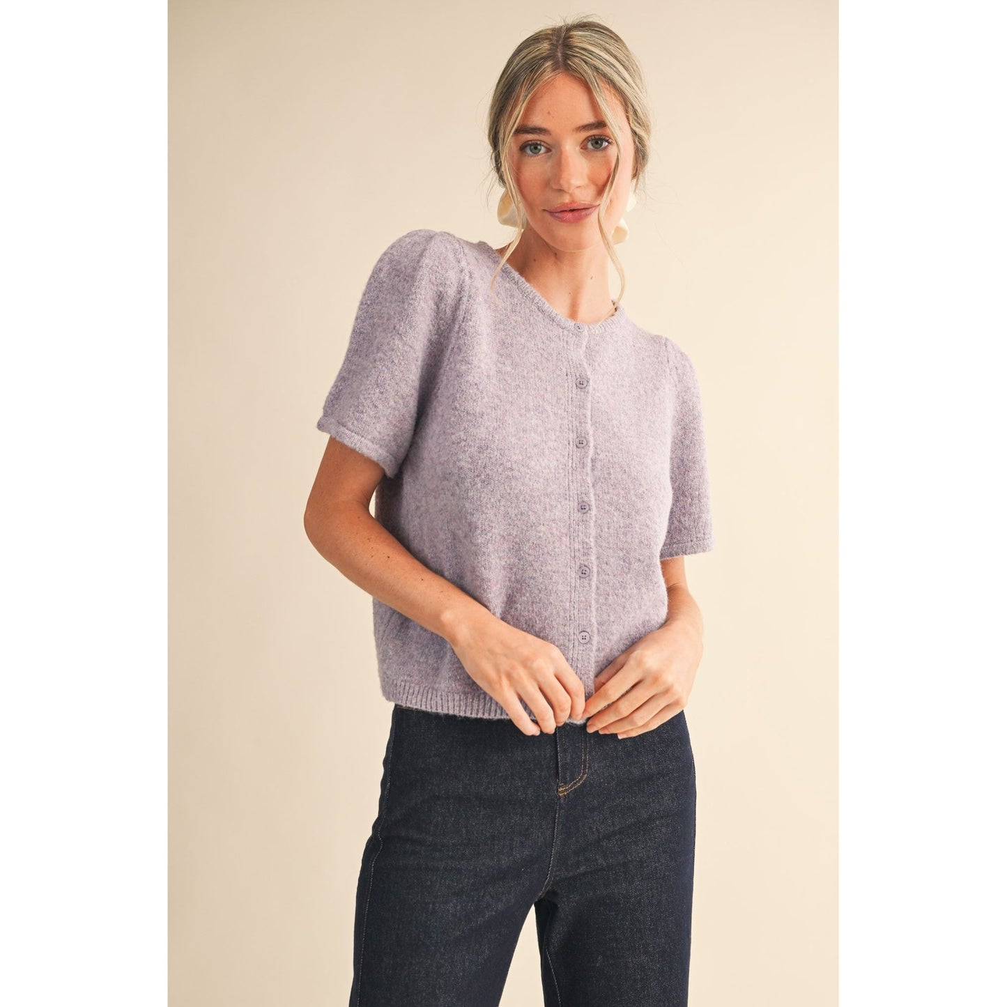 Woman wearing a light purple short-sleeve cardigan 