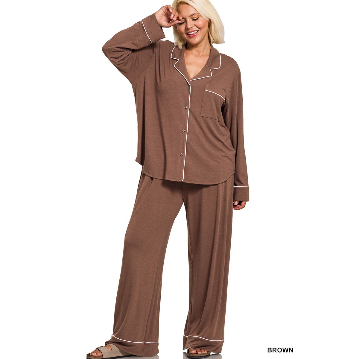 Woman wearing brown long sleeve and pants pajama set on a white background