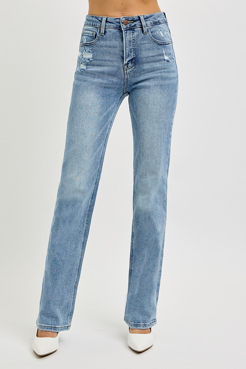 Medium wash denim jeans on a woman with white background.