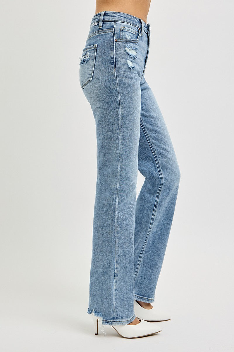Medium wash denim jeans on a woman with white background.