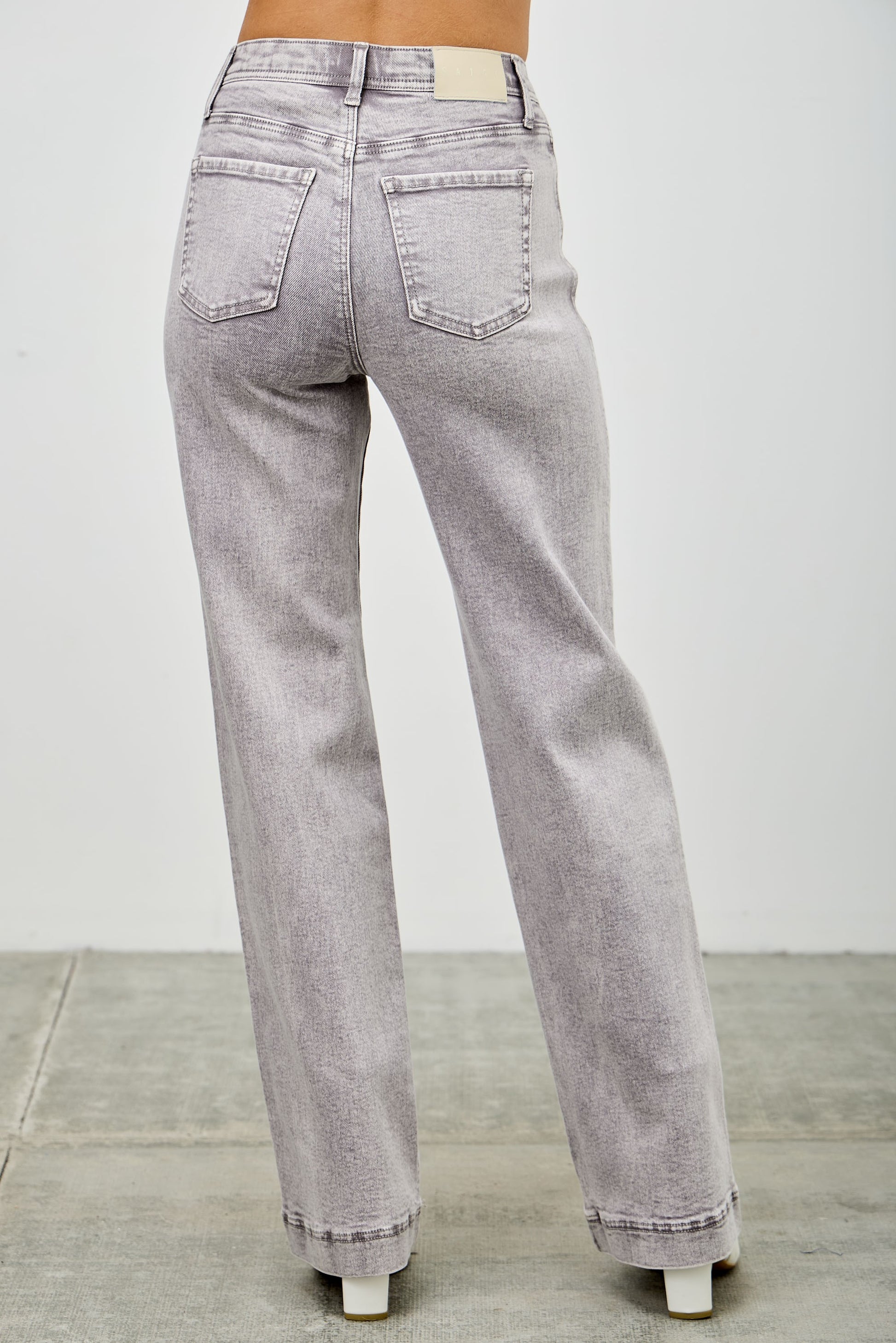Gray jeans on a women with a white background