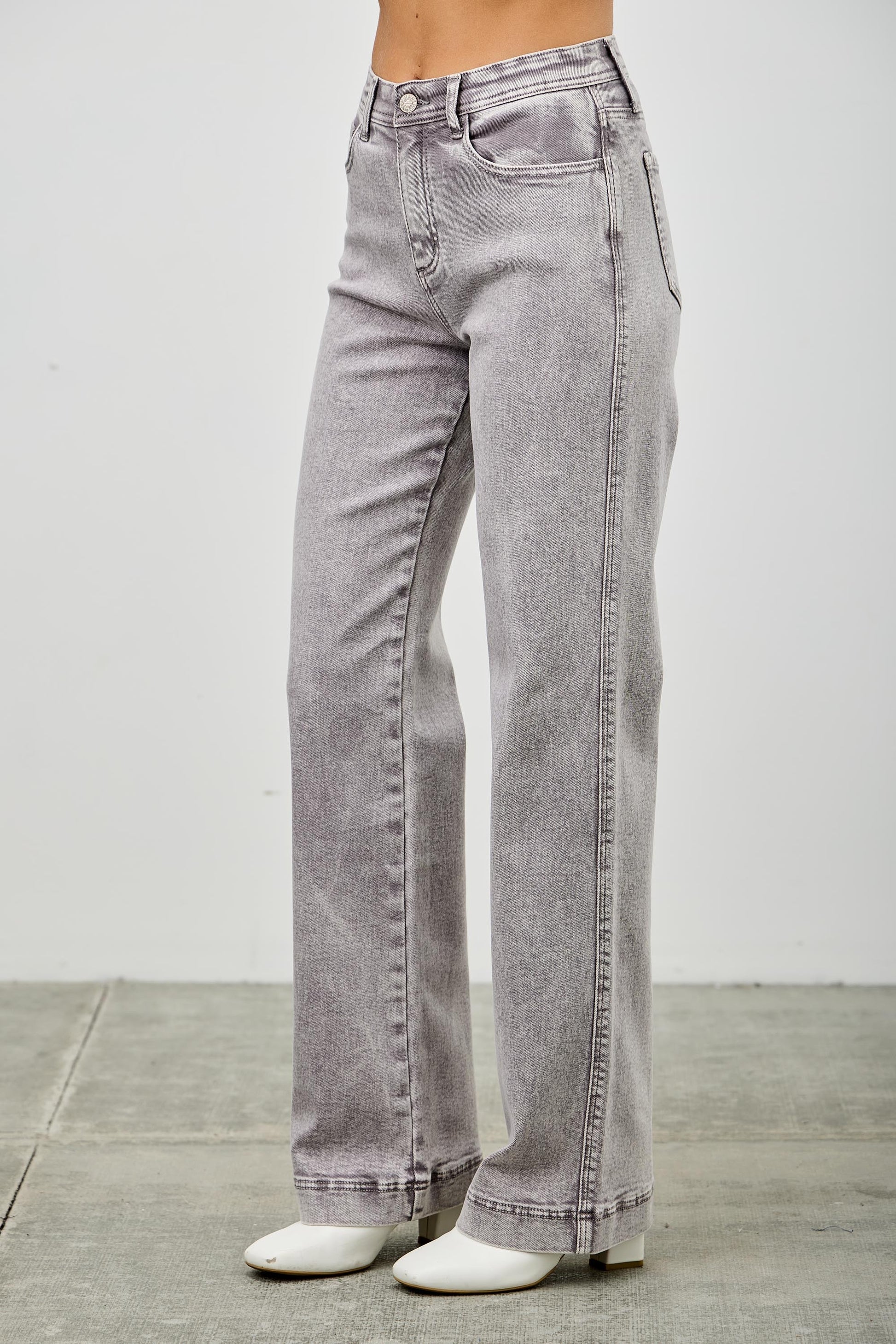Gray jeans on a women with a white background