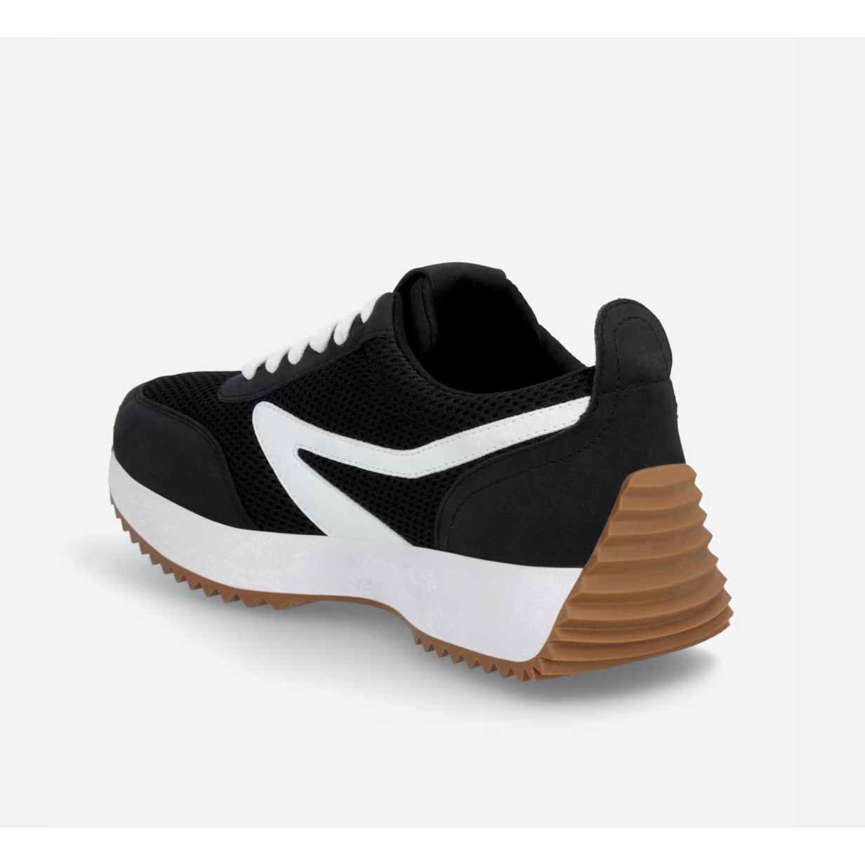 Black and white sneaker with brown sole on a light gray background