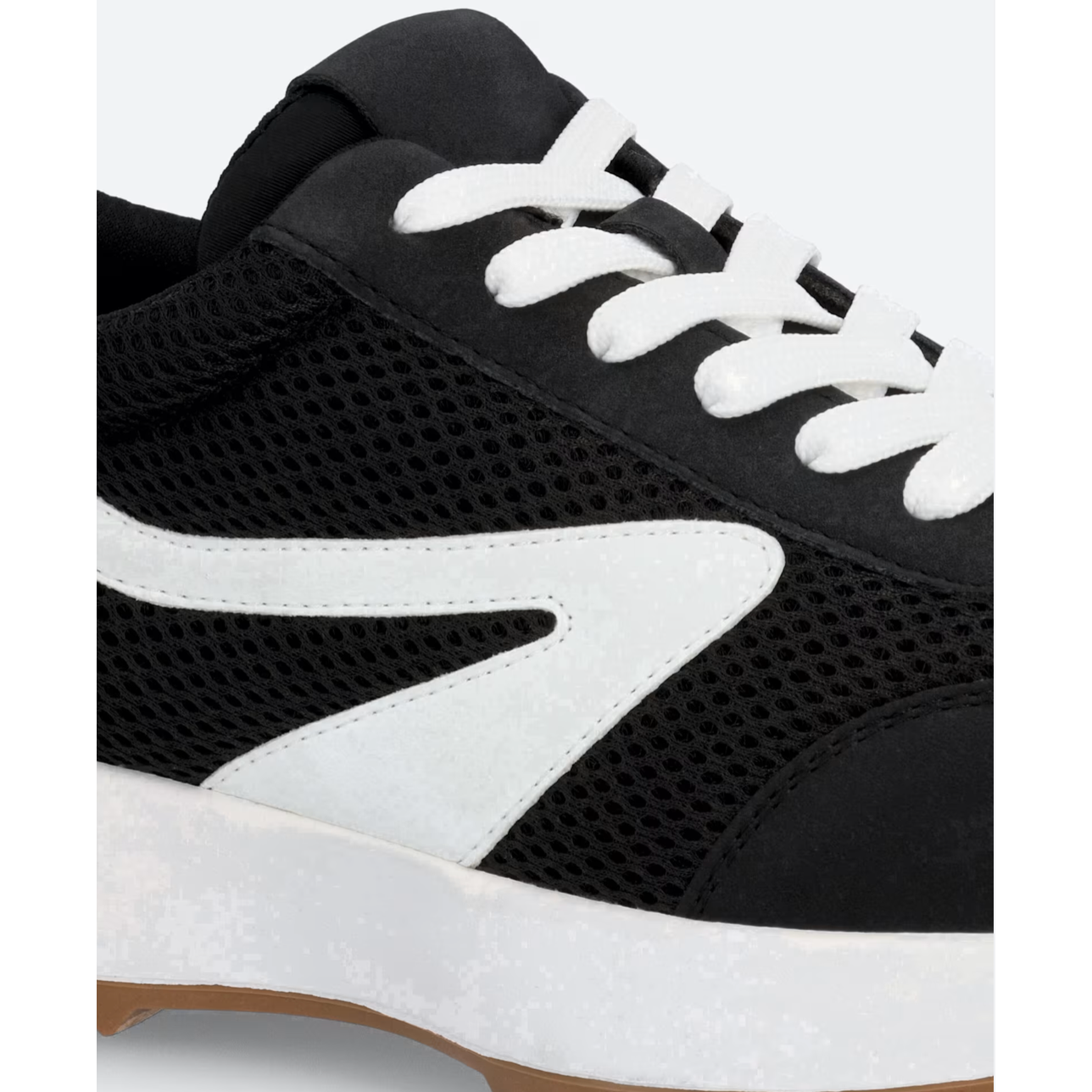 Black and white sneaker with a brand logo on a light gray background