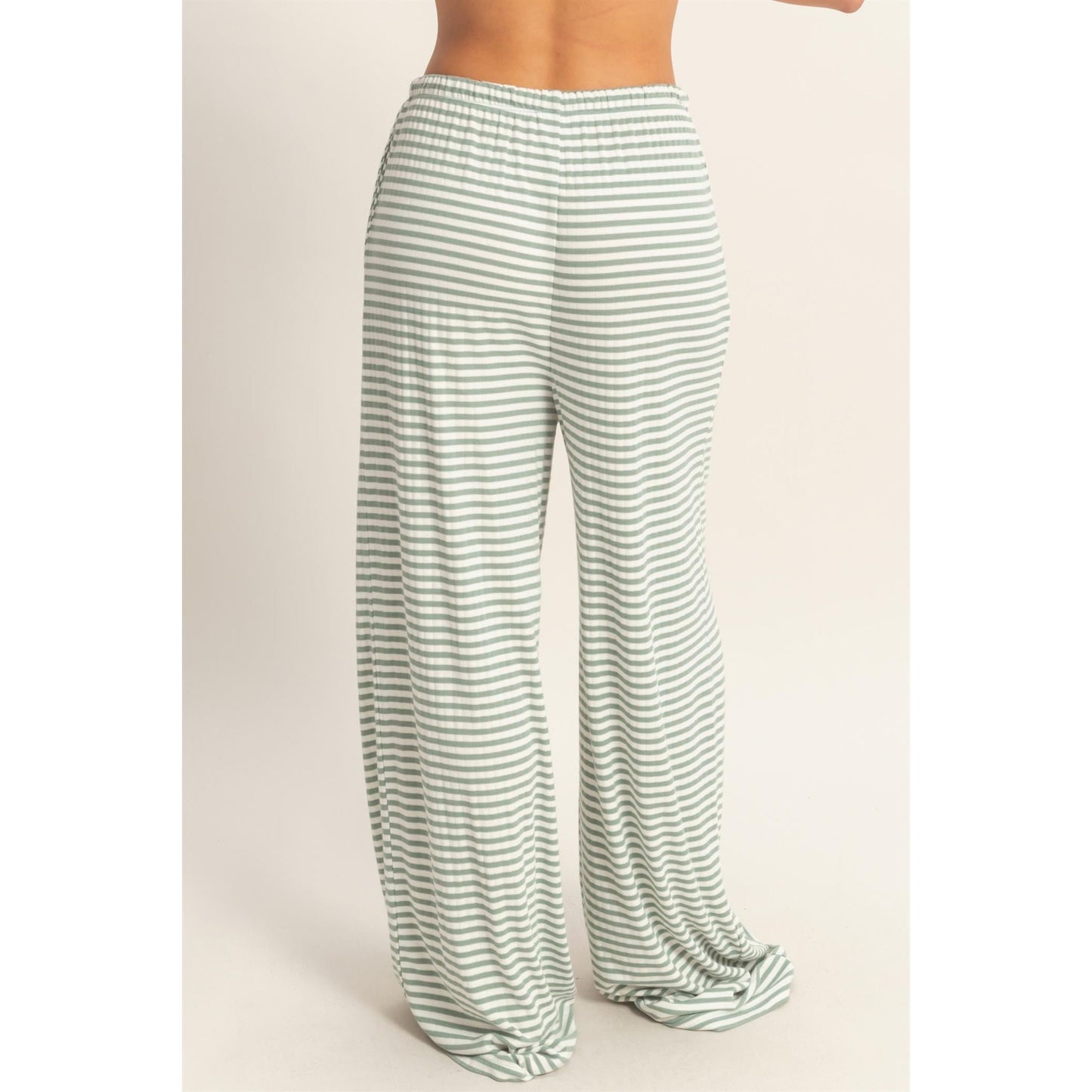 Women wearing a striped pajama pants and tank top set. 