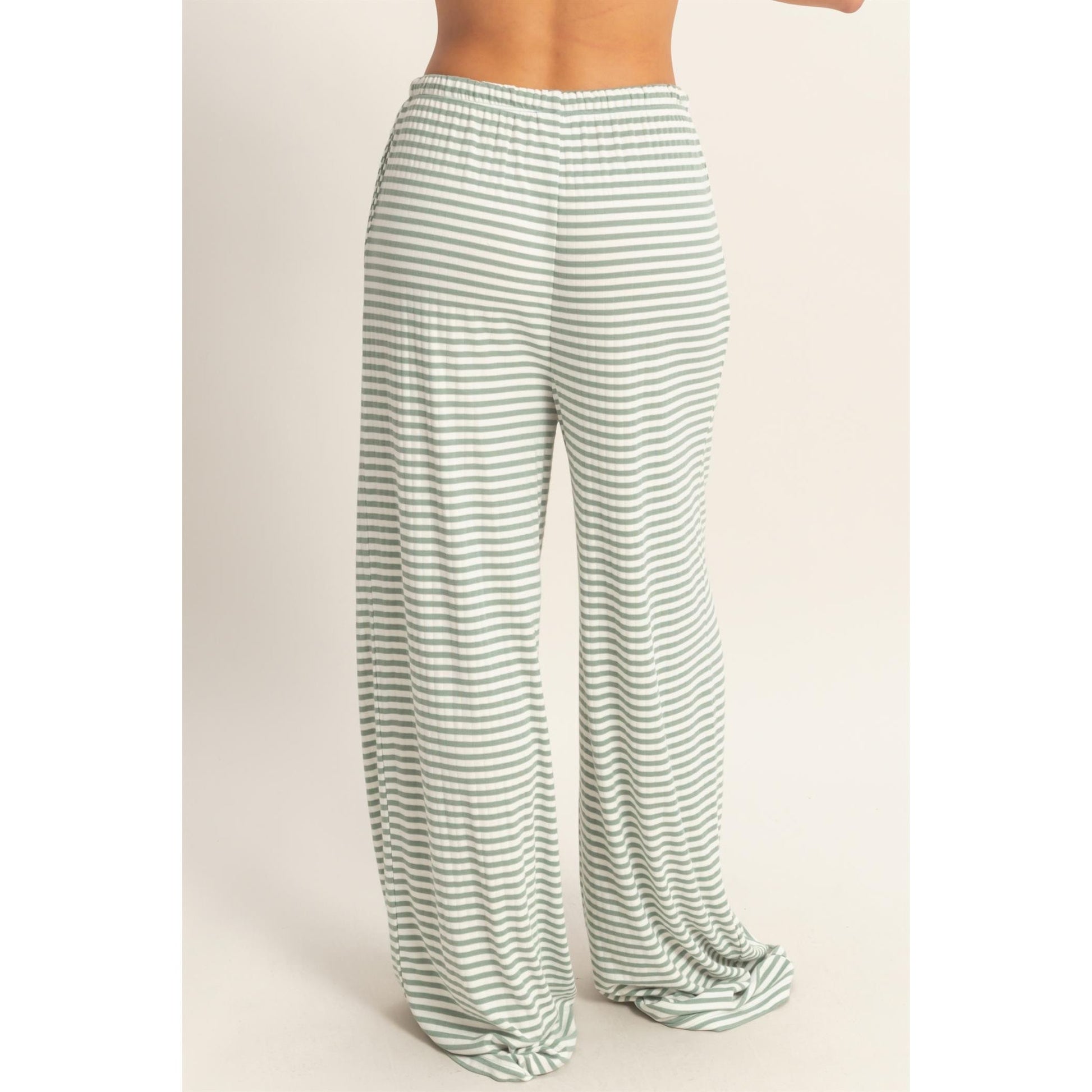 Women wearing a striped pajama pants and tank top set. 