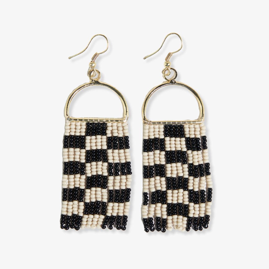 Pair of beaded earrings with black and white pattern on a white background