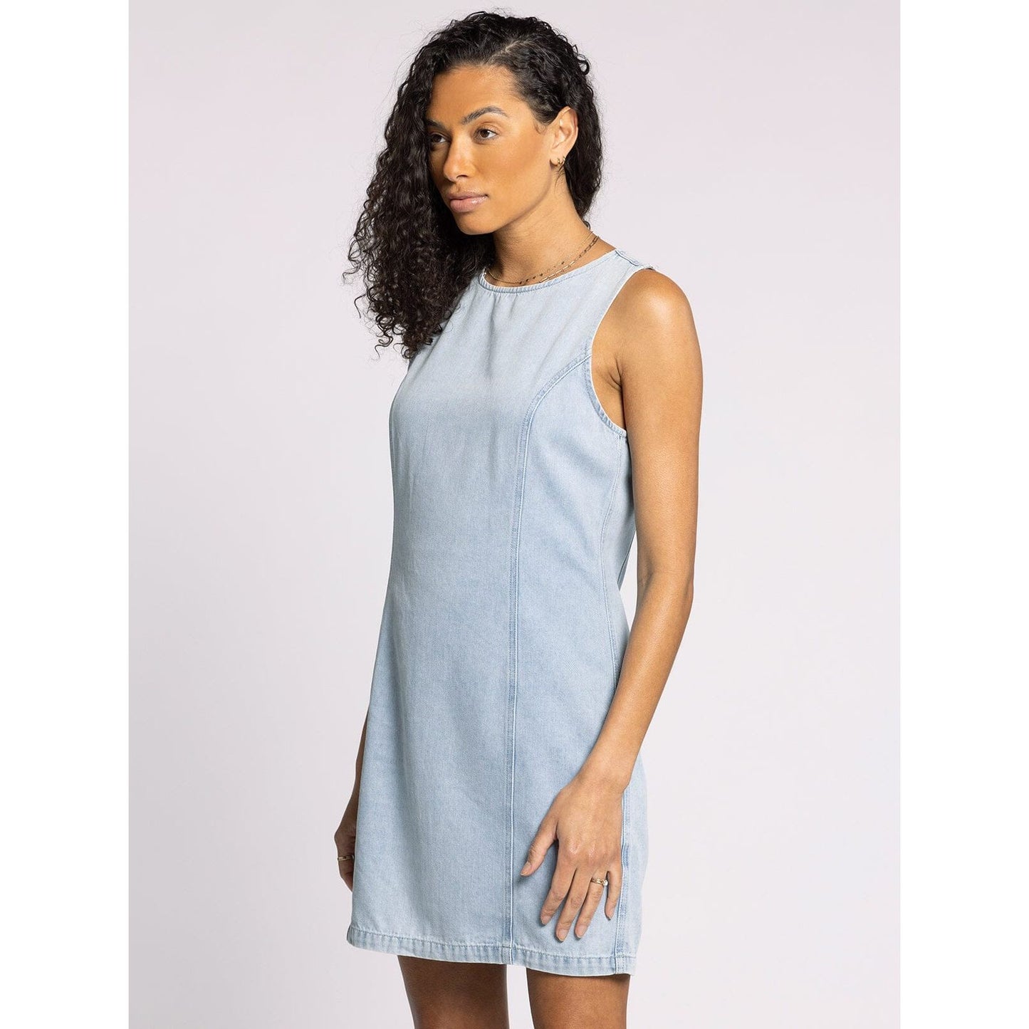 Woman wearing a light blue dress against a white background