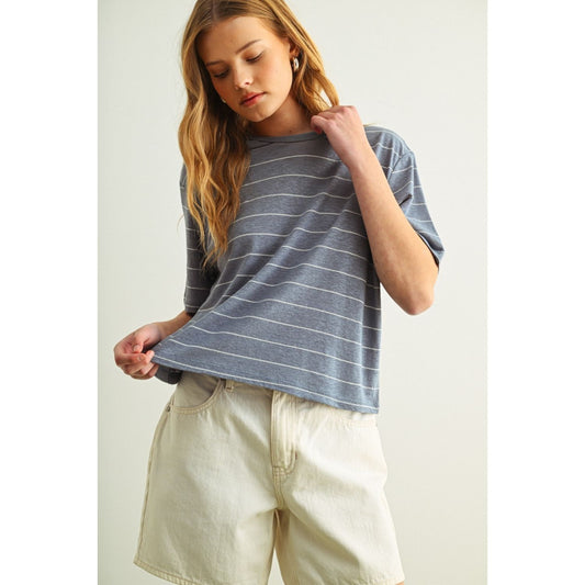 Woman is wearing a blue and white striped tee with a relaxed fit 