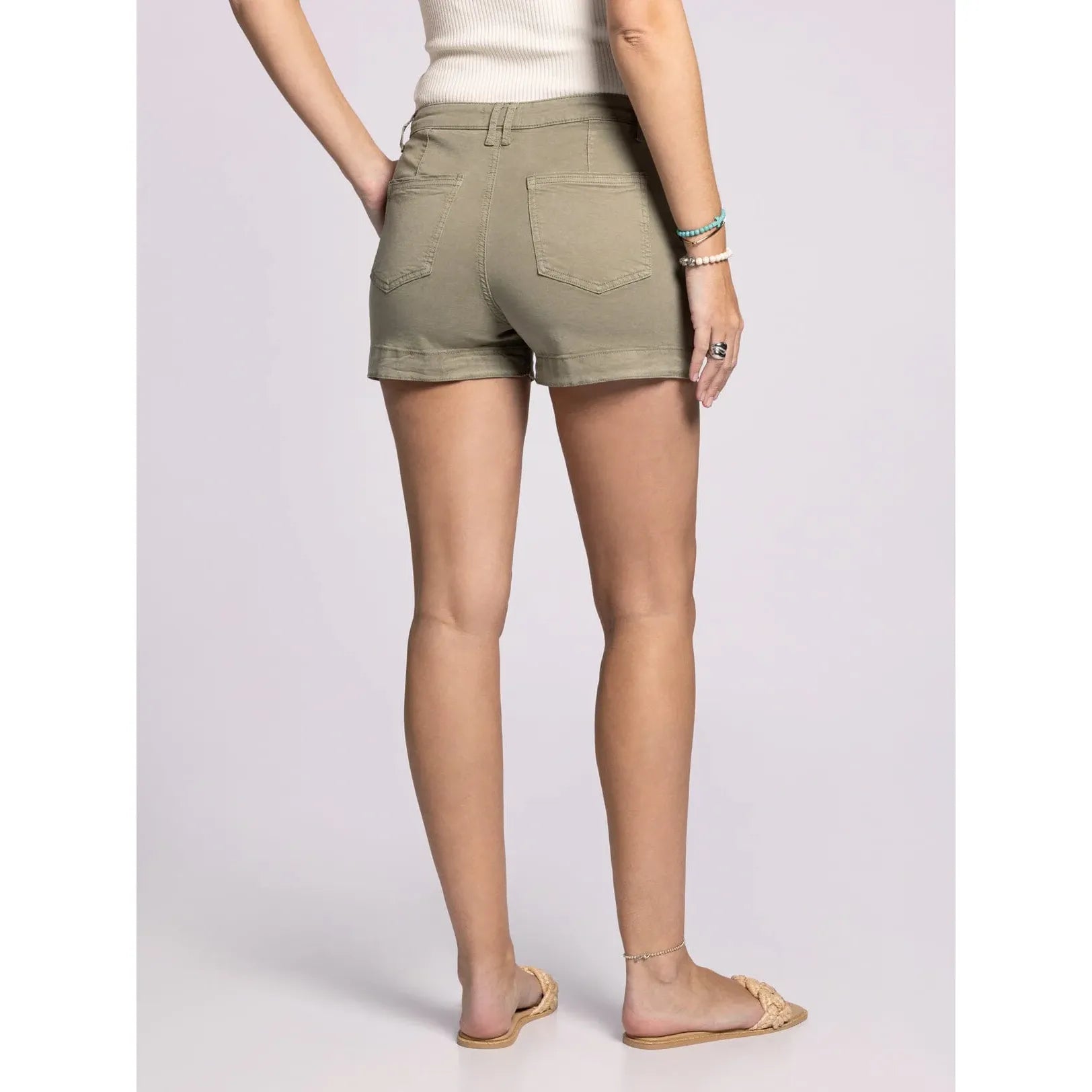 Person wearing olive green shorts on a plain background