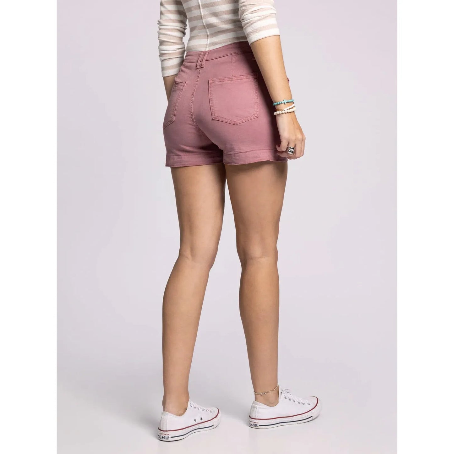 Person wearing pink shorts on a plain background