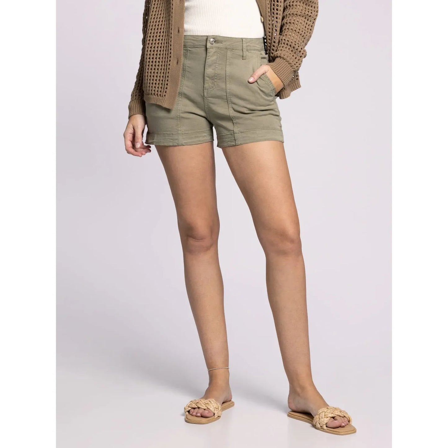 Person wearing green shorts on a plain background