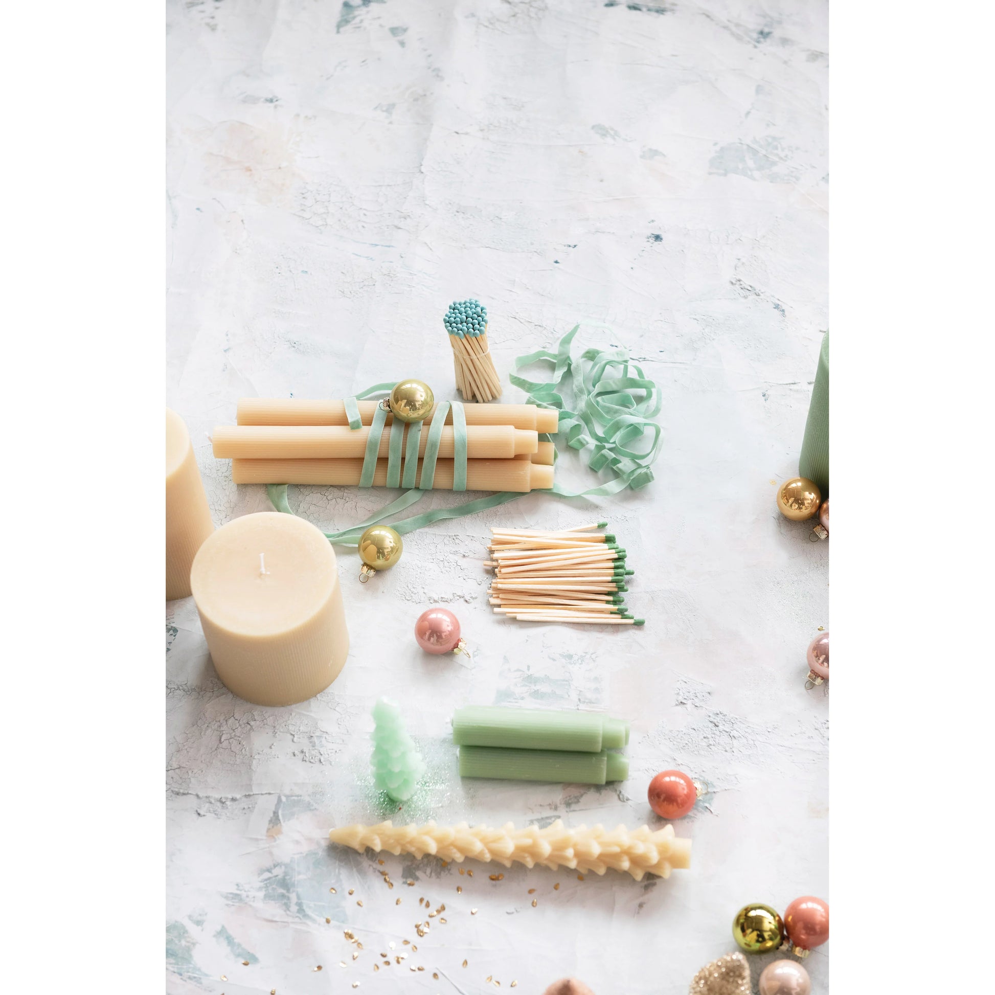 Decorative candles and matches on a marble surface